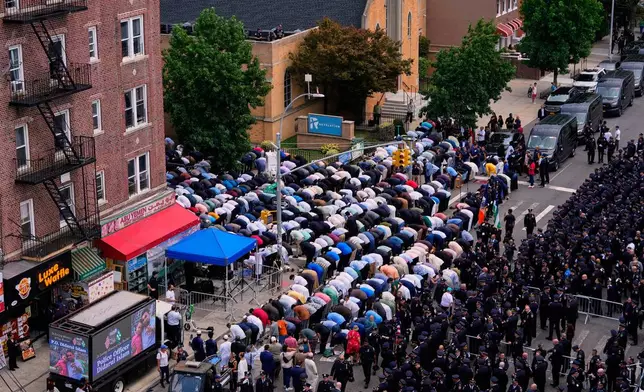 Muslims pray in the street outside the mosque during the funeral for NYPD officer Didarul Islam, Thursday, July 31, 2025, in New York. (AP Photo/Yuki Iwamura )