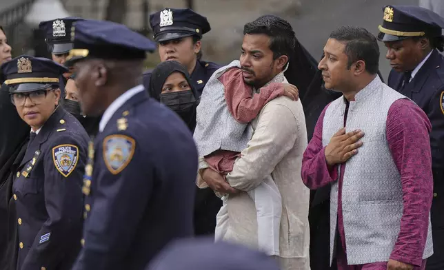 Family members of NYPD officer Didarul Islam walk in a procession after his funeral, Thursday, July 31, 2025, in New York. (AP Photo/Angelina Katsanis )