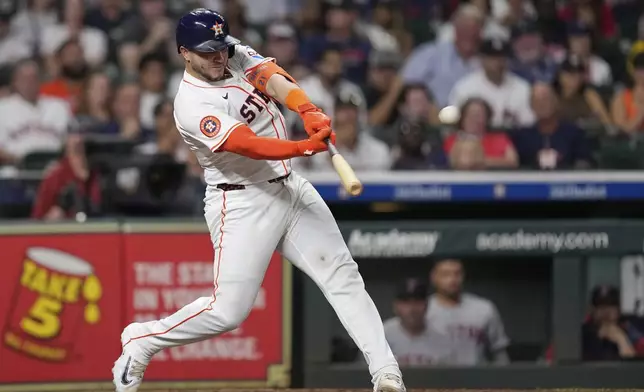 Houston Astros' Yainer Diaz hits a two-run home run against the Boston Red Sox during the sixth inning of a baseball game Wednesday, Aug. 13, 2025, in Houston. (AP Photo/David J. Phillip)