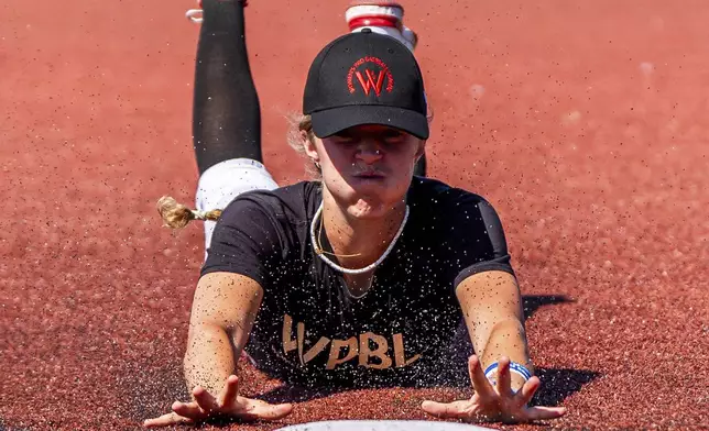 A player slides to third base during the first day of tryouts for the Women's Professional Baseball League, Friday, Aug 22, 2025, at the Washington Nationals Youth Baseball Academy in Washington. (AP Photo/Julia Demaree Nikhinson)