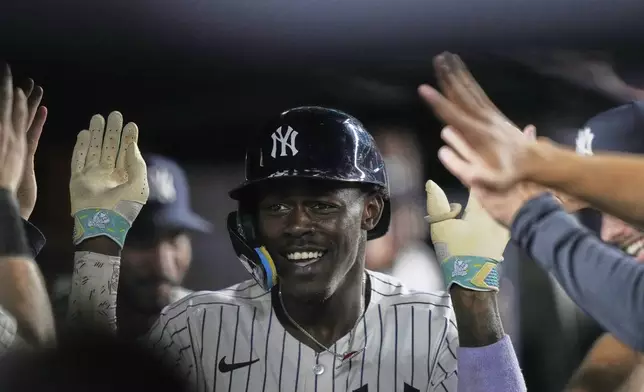 New York Yankees' Jazz Chisholm Jr. celebrates with teammates after hitting a home run during the eighth inning of a baseball game against the Minnesota Twins Monday, Aug. 11, 2025, in New York. (AP Photo/Frank Franklin II)