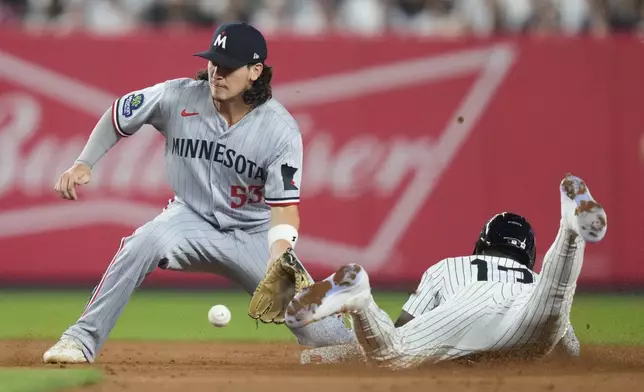 New York Yankees' Jazz Chisholm Jr., right, slides past Minnesota Twins' Ryan Fitzgerald (53) to steal second base during the sixth inning of a baseball game Monday, Aug. 11, 2025, in New York. (AP Photo/Frank Franklin II)