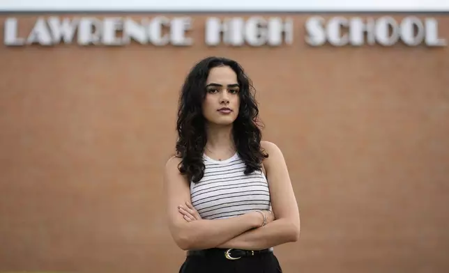 Natasha Torkzaban stands outside Lawrence High School, where she and other students have filed a lawsuit against the school district's use of digital surveillance software, Sunday, Aug. 3, 2025, in Lawrence, Kan. (AP Photo/Charlie Riedel)