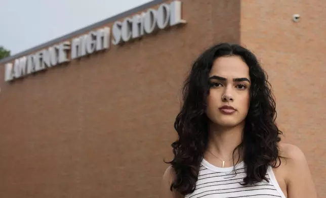 Natasha Torkzaban stands outside Lawrence High School, where she and other students have filed a lawsuit against the school district's use of digital surveillance software, Sunday, Aug. 3, 2025, in Lawrence, Kan. (AP Photo/Charlie Riedel)