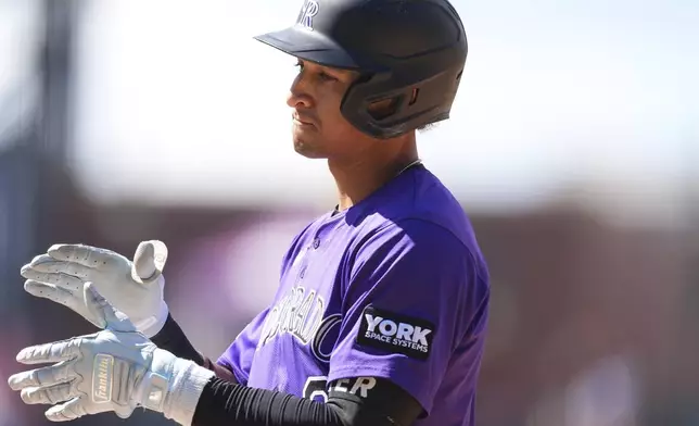 Colorado Rockies' Ryan Ritter reacts after singling to drive in two runs off Arizona Diamondbacks relief pitcher Jake Woodford in the seventh inning of a baseball game, Sunday, Aug. 17, 2025, in Denver. (AP Photo/David Zalubowski)