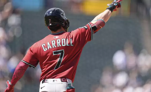 Arizona Diamondbacks' Corbin Carroll gestures to the bullpen as he circles the bases after hitting a solo home run off Colorado Rockies relief pitcher Luis Peralta in the sixth inning of a baseball game Sunday, Aug. 17, 2025, in Denver. (AP Photo/David Zalubowski)
