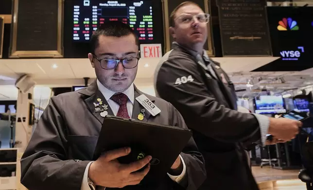 Traders Drew Cohen, left, and Ryan Falvey work on the floor of the New York Stock Exchange, Monday, Aug. 18, 2025. (AP Photo/Richard Drew)
