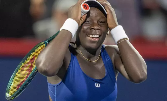 Victoria Mboko, of Canada, celebrates after her win over Marie Bouzkova, of Czechia, during third-round match action at the National Bank Open women's tennis tournament in Montreal, Thursday, July 31, 2025. (Christinne Muschi/The Canadian Press via AP)
