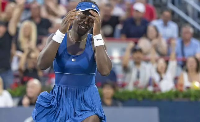 Victoria Mboko, of Canada, reacts following her win over Coco Gauff, of the United States, during round of 16 match action at the National Bank Open women's tennis tournament in Montreal, Saturday, Aug. 2, 2025. (Christinne Muschi/The Canadian Press via AP)
