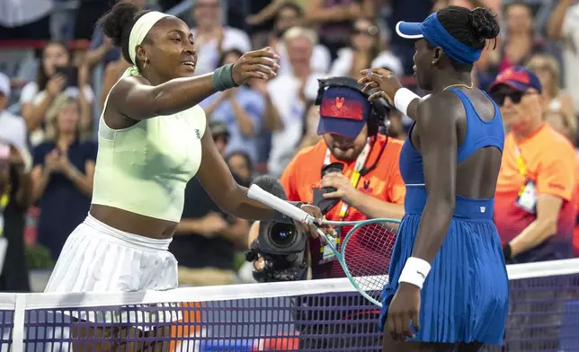 Victoria Mboko, right, of Canada, is congratulated after her win by Coco Gauff, left, of the United States, during round of 16 match action at the National Bank Open women's tennis tournament in Montreal, Saturday, Aug. 2, 2025. (Christinne Muschi/The Canadian Press via AP)