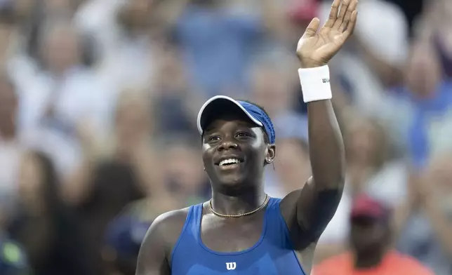 Victoria Mboko, of Canada, waves to the crowd following her win over Coco Gauff, of the United States, during round of 16 match action at the National Bank Open women's tennis tournament in Montreal, Saturday, Aug. 2, 2025. (Christinne Muschi/The Canadian Press via AP)