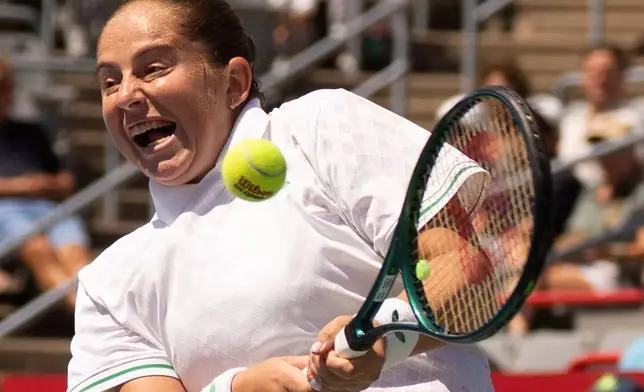 Jelena Ostapenko, of Latvia, hits a return to Naomi Osaka, of Japan, during the National Bank Open women’s tennis tournament, Friday, Aug. 1, 2025, in Montreal. (Christinne Muschi/The Canadian Press via AP)