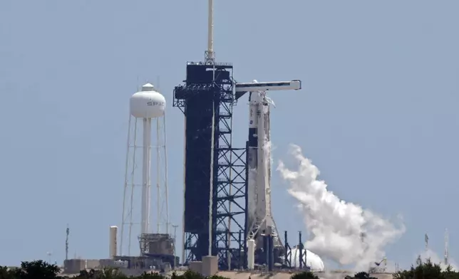 FILE - A SpaceX Falcon 9 rocket, with the crew Dragon capsule attached, vents fuel while sitting on Kennedy Space Center's Launch Pad 39-A, July 31, 2025, in Cape Canaveral, Fla. (AP Photo/Chris O'Meara, File)