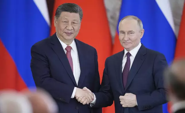 FILE - Russian President Vladimir Putin, right, and Chinese President Xi Jinpin shake hands at the Kremlin in Moscow, Russia, May 8, 2025. (AP Photo/Pavel Bednyakov, File)