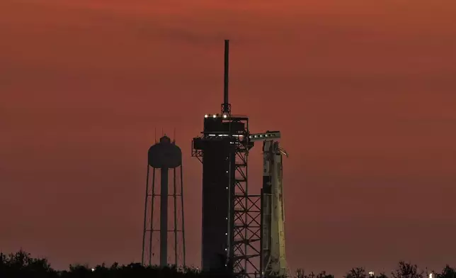 A SpaceX Falcon 9 rocket, with the crew Dragon capsule attached, sits on Kennedy Space Center's Launch Pad 39-A Friday, Aug. 1, 2025, in Cape Canaveral, Fla. (AP Photo/Chris O'Meara)