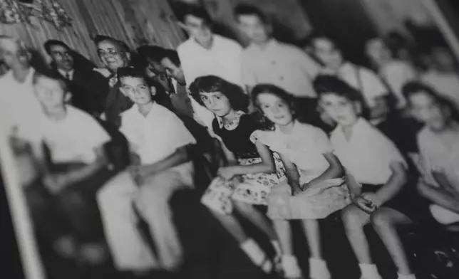 An old photo shows Fatima Igram Smejkal sitting with children whose families had immigrated to the United States from present-day Lebanon in the early 1900s, on Friday, Aug. 8, 2025, in Cedar Rapids, Iowa. (AP Photo/Jessie Wardarski)