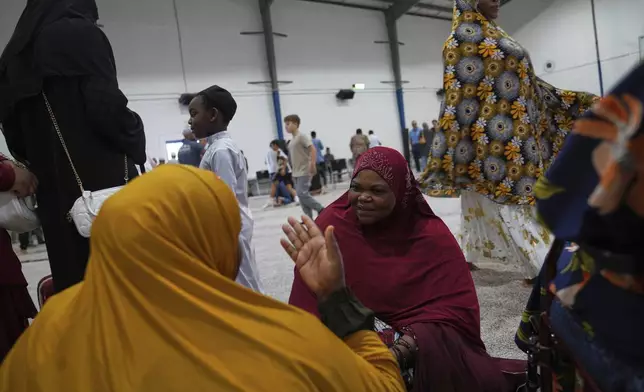 Community members talk after Friday prayer at the Islamic Center of Cedar Rapids on Friday, Aug. 8, 2025, in Cedar Rapids, Iowa. (AP Photo/Jessie Wardarski)