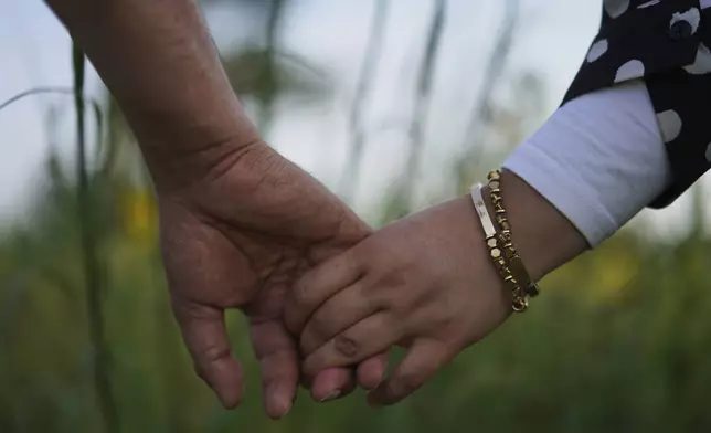 Faroz Waziri and his wife Mena, both refugees from Afghanistan who settled in Cedar Rapids, Iowa, roughly 10 years ago, hold hands on Friday, Aug. 8, 2025, in Cedar Rapids. (AP Photo/Jessie Wardarski)
