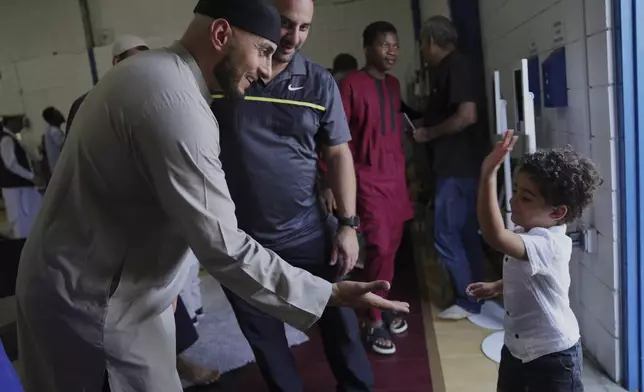 Community members talk after Friday prayer at the Islamic Center of Cedar Rapids on Friday, Aug. 8, 2025, in Cedar Rapids, Iowa. (AP Photo/Jessie Wardarski)