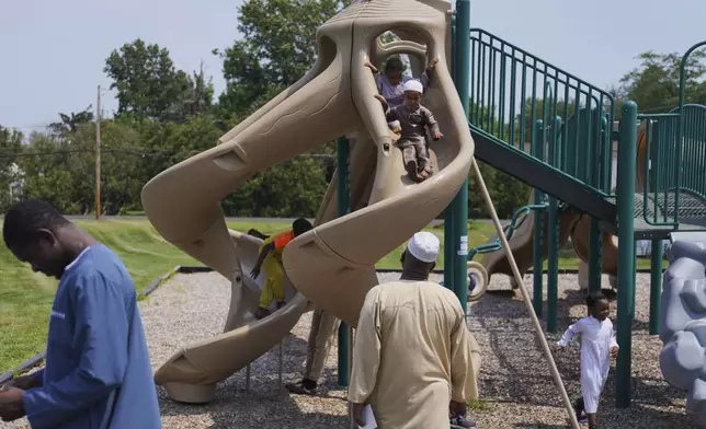 Children play outside after Friday prayer at the Islamic Center of Cedar Rapids on Aug. 8, 2025, in Cedar Rapids, Iowa. (AP Photo/Jessie Wardarski)