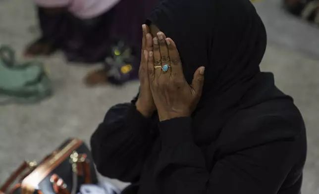A woman prays at the Islamic Center of Cedar Rapids on Friday, Aug. 8, 2025, in Cedar Rapids, Iowa. (AP Photo/Jessie Wardarski)
