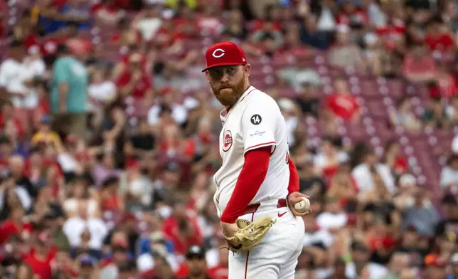 Cincinnati Reds pitcher Zack Littell looks towards first base in the third inning of a baseball game against the Milwaukee Brewers, Saturday, Aug. 16, 2025, in Cincinnati. (AP Photo/Michael Swensen)