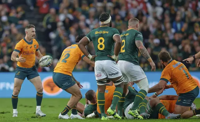 Australia's Nic White, left, holds the ball following a scrum during a rugby championship test match between South Africa and Australia, at Ellis Park stadium in Johannesburg, South Africa, Saturday, Aug. 16, 2025. (AP Photo/Frans Lombard)