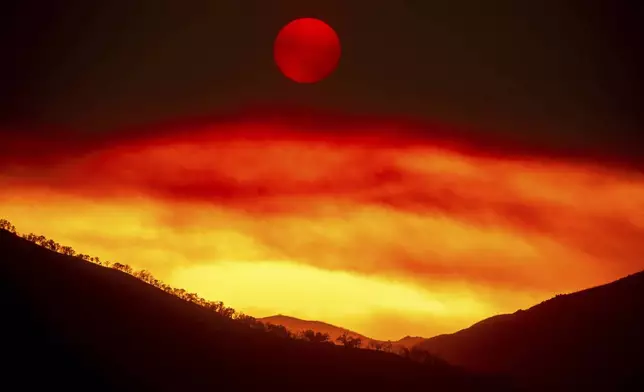 Smoke from the Gifford Fire fills the sky as the sun sets over Los Padres National Forest, Calif., on Monday, Aug. 4, 2025. (AP Photo/Noah Berger)