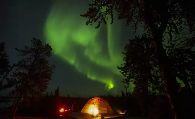 The northern lights, also known as the aurora borealis, are seen in the night sky near Yellowknife in Canada's Northwest Territories, early Wednesday, Aug. 20, 2025. (AP Photo/Mark Schiefelbein)