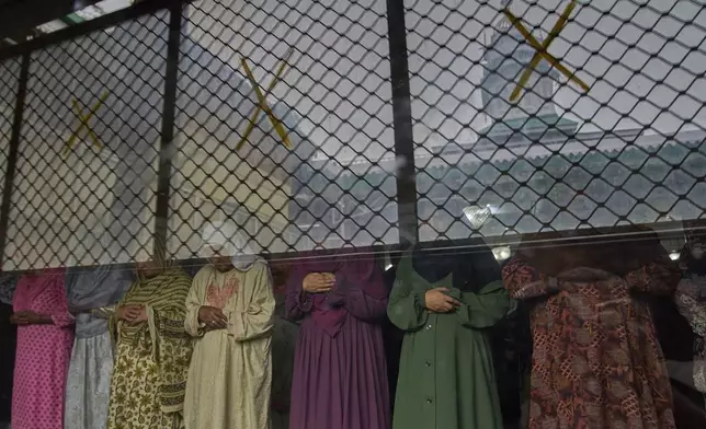 Kashmiri Muslim women offer prayers outside the shrine of Sufi saint Hazrat Sheikh Hamza Makhdoom, commonly known as Sultan-Ul-Arifeen, during the saint's Urs, or yearly commemoration, in Srinagar, Indian controlled Kashmir, Tuesday, Aug. 19, 2025. (AP Photo/ Dar Yasin)
