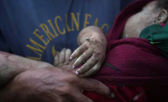 Alaa Hassanein carries the body of his 4-year-old niece, Sara Hassanein, who was killed in an Israeli military strike on a school used as a shelter, outside Al-Shifa Hospital, in Gaza City, Friday, Aug. 22, 2025. (AP Photo/Abdel Kareem Hana)