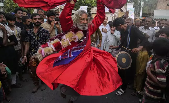 A spiritual path devotee locally called 'Malang' performs traditional Sufi trance dance called 'Dhamaal' during celebrations of the three-day annual festival or 'Urs' of mystic and scholar, Hazrat Ali Hajveri, popularly known as Data Ganj Bakhsh at his shrine, in Lahore, Pakistan, Wednesday, Aug. 13, 2025. (AP Photo/K.M. Chaudary)