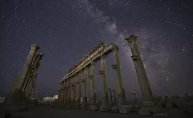 The ruins of the ancient city of Palmyra under a star-studded sky in Syria, in the late hours of Tuesday, Aug. 26, 2025.(AP Photo/Ghaith Alsayed)