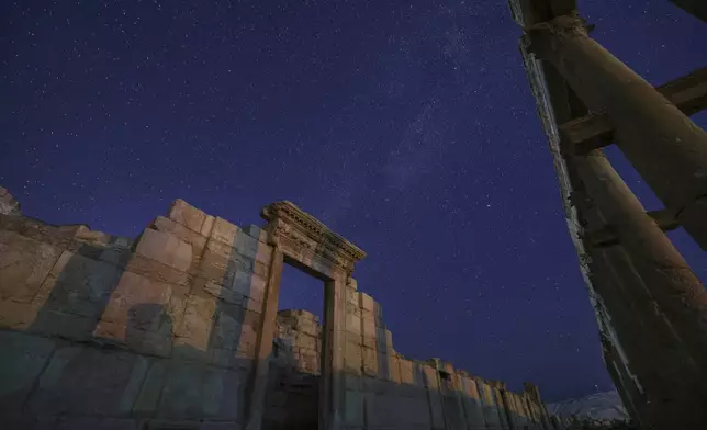 The rear gate of the Roman Theater in the ancient city of Palmyra is seen under a star-studded sky in Syria, early Wednesday, Aug. 27, 2025. (AP Photo/Ghaith Alsayed)