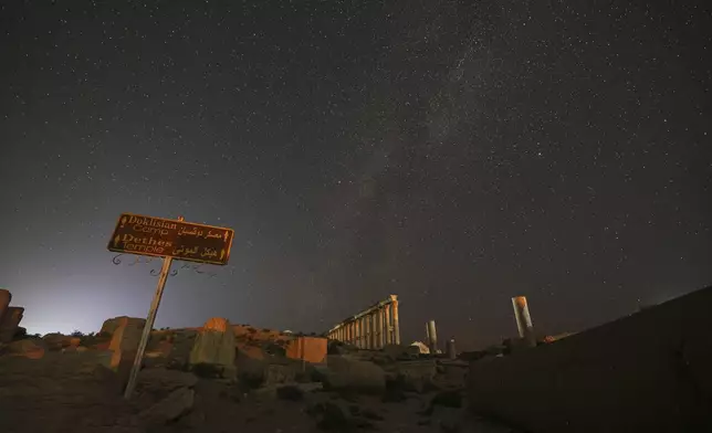 The ruins of the ancient city of Palmyra under a star-studded sky in Syria, in the early hours of Wednesday, Aug. 27, 2025.(AP Photo/Ghaith Alsayed)