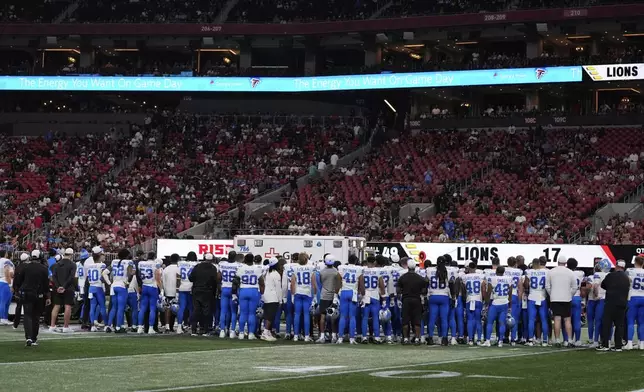 Detroit Lions players stand on the field after safety Morice Norris was injured during the second half of an NFL preseason football game against the Atlanta Falcons Friday, Aug. 8, 2025, in Atlanta. (AP Photo/Brynn Anderson)