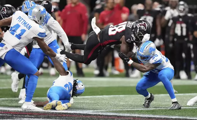 Detroit Lions safety Morice Norris (26) is hit in the helmet by Atlanta Falcons running back Nathan Carter (38) during the second half of an NFL preseason football game Friday, Aug. 8, 2025, in Atlanta. (AP Photo/Brynn Anderson)