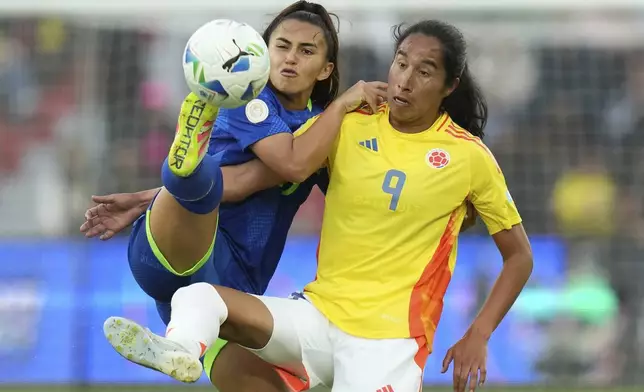 Brazil's Mariza, left, and Colombia's Mayra Ramirez battle for the ball during the Women's Copa America final soccer match at Rodrigo Paz Delgado stadium in Quito, Ecuador, Saturday, Aug. 2, 2025. (AP Photo/Dolores Ochoa)
