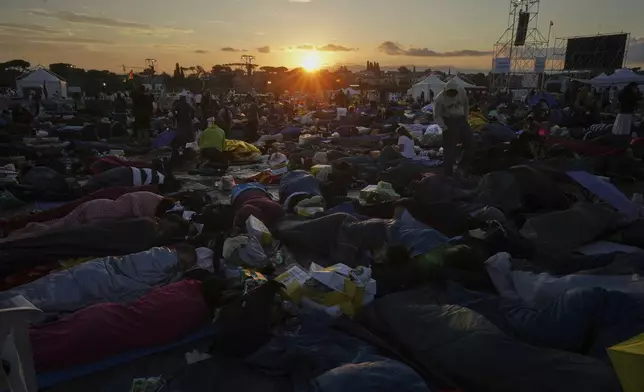 Young people wake up after spending the night at the Tor Vergata field in Rome as they participate in the Youths Jubilee, Sunday, Aug. 3, 2025. (AP Photo/Andrew Medichini)