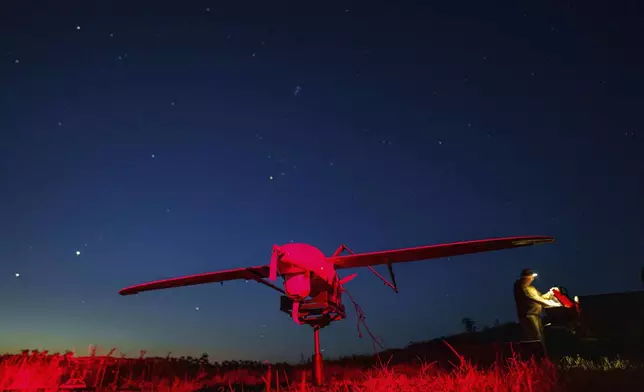 Ukrainian National Guard serviceman of 3rd brigade «Spartan» prepares for flight a Penguin UAV near the frontline at Pokrovsk direction, Ukraine, on Wednesday, August 6, 2025. (AP Photo/Evgeniy Maloletka)