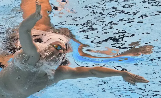 Leon Marchand of France competes in the men's 400-meter individual medley heats at the World Aquatics Championships in Singapore, Sunday, Aug. 3, 2025. (AP Photo/Lee Jin-man)