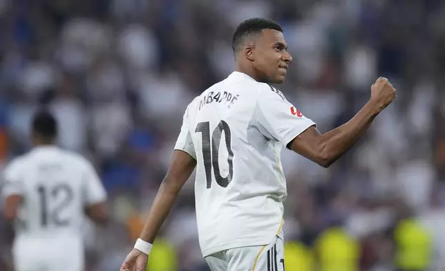 Real Madrid's Kylian Mbappe celebrates after scoring from a penalty kick during the La Liga soccer match between Real Madrid and Osasuna in Madrid, Spain, Tuesday, Aug. 19, 2025. (AP Photo/Manu Fernandez)