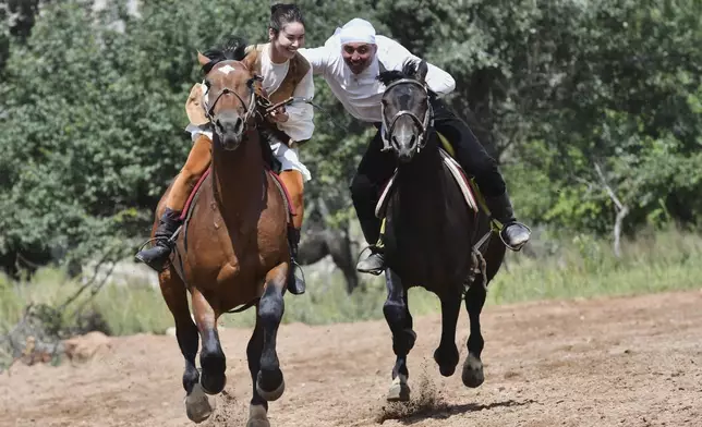 Kyrgyz riders attend the game "catch the girl" during the Traditional Eagle Hunting Salbuurun Festival on the southern shore of Issyk-Kul lake, 213 km (132 miles) southeast of Bishkek, Kyrgyzstan, on Saturday, Aug. 2, 2025. (AP Photo/Vladimir Voronin)