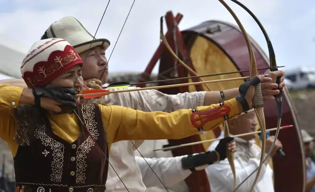 Kyrgyz hunters compete in archery during the Traditional Eagle Hunting Salbuurun Festival on the southern shore of Issyk-Kul lake, 213 km (132 miles) southeast of Bishkek, Kyrgyzstan, on Saturday, Aug. 2, 2025. (AP Photo/Vladimir Voronin)