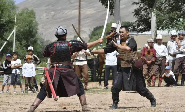 Kyrgyz hunters dressed in historical military clothing perform during the Traditional Eagle Hunting Salbuurun Festival on the southern shore of Issyk-Kul lake, 213 km (132 miles) southeast of Bishkek, Kyrgyzstan, on Saturday, Aug. 2, 2025. (AP Photo/Vladimir Voronin)