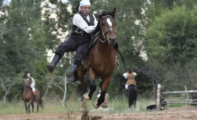 A Kyrgyz rider shows his skills during the Traditional Eagle Hunting Salbuurun Festival on the southern shore of Issyk-Kul lake, 213 km (132 miles) southeast of Bishkek, Kyrgyzstan, on Saturday, Aug. 2, 2025. (AP Photo/Vladimir Voronin)