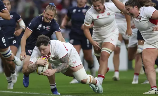 Hannah Botterman of England goes over the line to score a try during the group A match at the 2025 Women's Rugby World Cup between England and the United States in Sunderland, England, Friday, Aug. 22, 2025. (AP Photo/Scott Heppell)