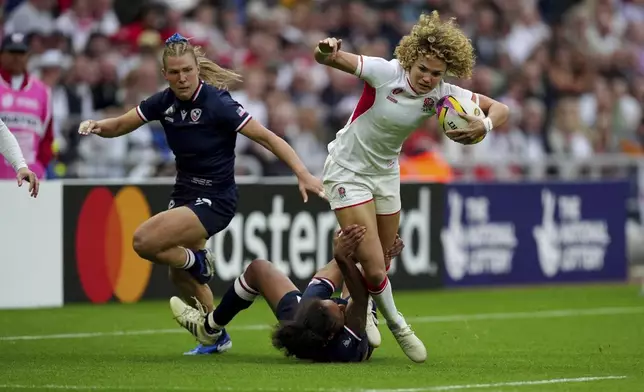 England's Ellie Kildunne, right, is tackled by USA's Bulou Mataitoga during the group A match at the 2025 Women's Rugby World Cup between England and the United States in Sunderland, England, Friday, Aug. 22, 2025. (Mike Egerton/PA via AP)