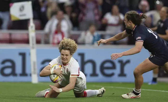 Ellie Kildunne of England dives to the ground as she scores a try during the group A match at the 2025 Women's Rugby World Cup between England and the United States in Sunderland, England, Friday, Aug. 22, 2025. (AP Photo/Scott Heppell)