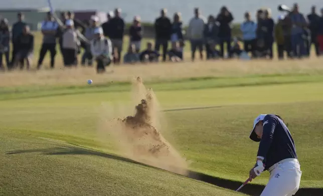 Rio Takeda of Japan plays out of a bunker on the 18th hole during the third round of the Women's British Open golf championship, at Royal Porthcawl Golf Club in Porthcawl, Wales, Saturday, Aug. 2, 2025. (AP Photo/Kin Cheung)